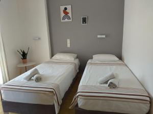 two beds sitting next to each other in a room at Villa Argiris in Agios Stefanos