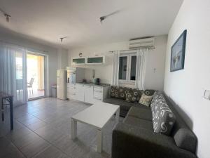 a living room with a couch and a table at Apartments Andrea in Stara Novalja