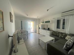 a living room with a couch and a table at Apartments Andrea in Stara Novalja