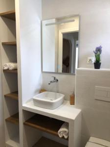 a bathroom with a sink and a mirror at El Chalet in Punta Umbría +42 photos