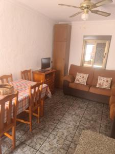 a living room with a table and a couch at Apartamento Mari in Agua Amarga