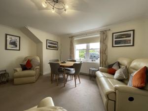 a living room with a couch and a table and chairs at Maiden Moor in Keswick