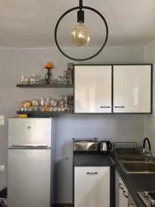 a kitchen with a white refrigerator and a sink at Sunset Villa in Siófok