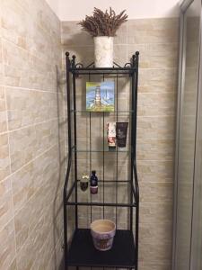 La salle de bains est pourvue d'une douche avec une étagère noire. dans l'établissement Fig&Lavender Apartment, à Šmarje
