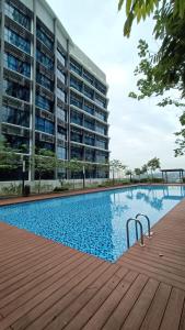 a swimming pool in front of a building at Pacific Towers Star Seksyen 13 PJ Jaya One Parking Netflix Pool Kitchen in Petaling Jaya