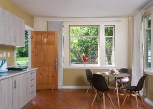 a kitchen with a table and chairs and a window at Airport Costa Rica B&B in Alajuela City +21 photos