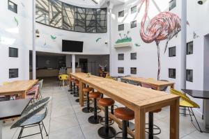 a room with tables and chairs and a large ceiling at Victoria Garden Bordeaux Centre in Bordeaux