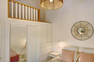 a bedroom with a bed and a mirror at Bungalow Sonemar Sunshine in Maspalomas +14 photos