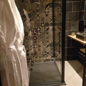 a shower with a glass door in a bathroom at La Cabane Enchanteresse in Illoud +20 photos
