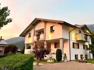 a large building with flowers on the windows at La Finestra sul Giardino - B&B in Cavedine