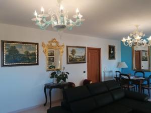 uma sala de estar com um sofá e um lustre em B&BYanet's Beautiful House em Civitavecchia