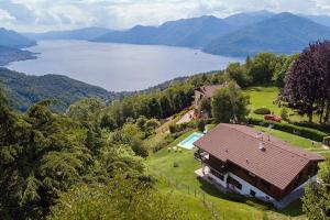 a house on a hill with a view of a lake at Villa Tirolese in Due Cossani