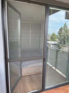 a sliding glass door with a view of a balcony at Apartment Sun Lakes - Sever in Senec