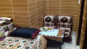 a room with two chairs and a table with pillows at Posh, Nice Foreigner Area Lajpat Ngar Luxury Room in New Delhi +33 photos
