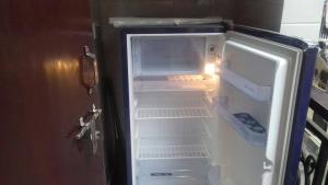 an open refrigerator with its door open and its door at Posh, Nice Foreigner Area Lajpat Ngar Luxury Room in New Delhi
