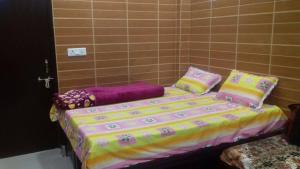a bed with pillows on it in a room at Posh, Nice Foreigner Area Lajpat Ngar Luxury Room in New Delhi