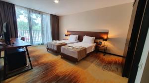 Ένα ή περισσότερα κρεβάτια σε δωμάτιο στο CAROUSEL HOTEL