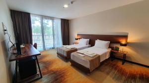 Ένα ή περισσότερα κρεβάτια σε δωμάτιο στο CAROUSEL HOTEL