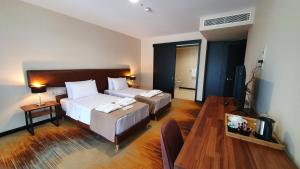 Ένα ή περισσότερα κρεβάτια σε δωμάτιο στο CAROUSEL HOTEL