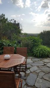 a wooden table and two chairs on a patio at Mayrose Cottage, Charming Cornish Cottage for the perfect escape... in Camelford