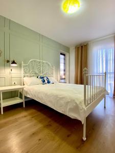 a bedroom with a white bed and a window at Apart.Boutique B. Mangalia in Mangalia