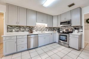 a large kitchen with white cabinets and appliances at Bermuda Drive Abode in Fleming Island