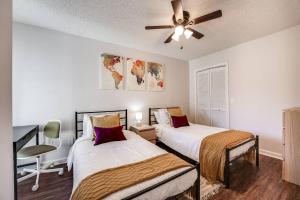 a bedroom with two beds and a ceiling fan at Bermuda Drive Abode in Fleming Island