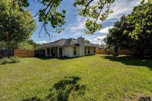 a white house with a fence and a yard at Bermuda Drive Abode in Fleming Island +39 photos