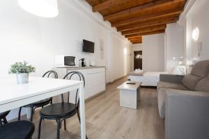 a living room with a couch and a table at Outdoor Apartaments - Spot in Andorra la Vella