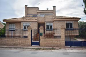 une maison en briques avec un portail en face de celle-ci dans l'établissement Salvadora Luminosa, à Murcie