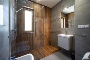 a bathroom with a sink and a toilet and a shower at Villa Arkadia PORTUS in Dziwnów +56 photos