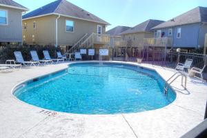 una piscina con sillas en un complejo de apartamentos en Guest Cottage 30G, en Myrtle Beach