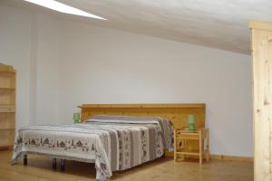 ein Schlafzimmer mit einem Bett mit einem Kopfteil aus Holz in der Unterkunft Agape in Caprino Veronese