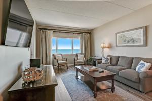 a living room with a couch and a table at 327 Sandcastle condo in Fernandina Beach
