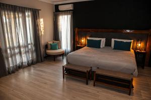 a bedroom with a large bed with blue pillows at Algodon Wine Estates & Champions Club in San Rafael