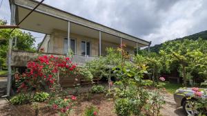 a house with flowers in front of it at Shin•შინ in Kutaisi