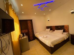 a bedroom with a bed and a tv in it at Sahara Pyramids Inn in Cairo +144 photos