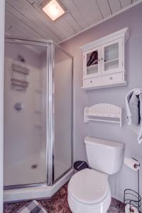 a white bathroom with a toilet and a shower at Modern Winnipesaukee Lake Front Retreat Siena in Alton