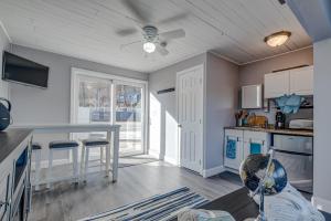 a kitchen with a table and a ceiling fan at Modern Winnipesaukee Lake Front Retreat Siena in Alton +5 photos