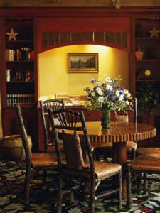 a dining room with a table and chairs and flowers at Teton Club in Teton Village