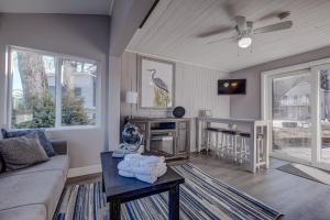 a living room with a couch and a table at Modern Winnipesaukee Lake Front Retreat Siena in Alton