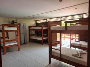 a dorm room with several bunk beds in it at Iduna Hostel in Pipa