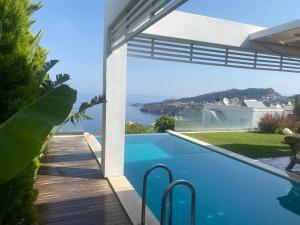 a swimming pool with a view of the water at Villa Aleph-Kiralık Müstakil havuzlu lüx villa in Bodrum City