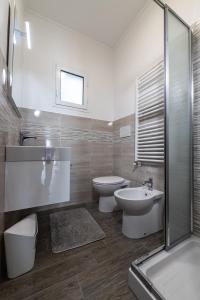 a bathroom with two toilets and a sink and a shower at Sanremo Dream - Casa Camilla in Sanremo