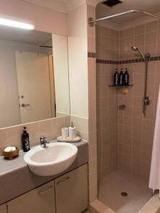a bathroom with a sink and a shower at City River Views Free Parking WIFI Netflix Wine in Perth