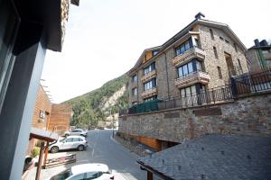 a building with cars parked on the side of a street at Outdoor Apartaments - Ski in Canillo