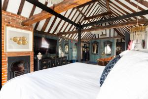 una camera con letto bianco e camino di Staycations Maldon a Maldon