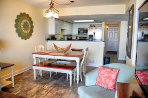 a dining room and kitchen with a table and chairs at Waterpoint II 402 in Myrtle Beach