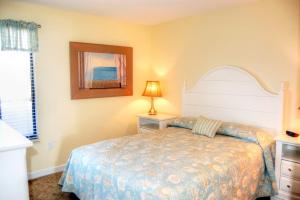 a bedroom with a bed and a picture on the wall at Waterpoint II 402 in Myrtle Beach