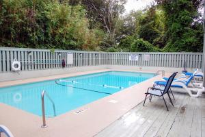a swimming pool with a chair at Dry Dock 101 in Myrtle Beach
